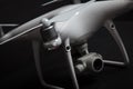 Close up of propeller of white drone Quadrocopter with camera on gimbal on dark background