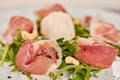 Close up of prosciutto and arugula salad. Royalty Free Stock Photo