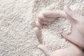 Close-up of a protectively gloved hand holding a lot of white plastic polymer granules