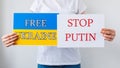 close up of a Protester hands holding cardboard Banner with the words stop putin free ukraine Royalty Free Stock Photo