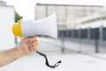 close up protester holding megaphone. High quality photo