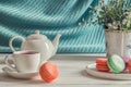 Close up. Provence breakfast. Colorful macarons on a round plate, a cup of berry tea, a lavender, a teapot.