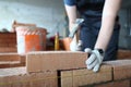 Skilled bricklayer putting red block Royalty Free Stock Photo