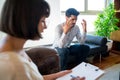 Psychologist taking notes during therapy session. Royalty Free Stock Photo