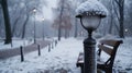Close-Up of a Public Bench and Lamp Post Encrusted with Frost, Abandoned Park in the Background, Emphasizing the Royalty Free Stock Photo