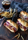 Close up of pulled pork sliders on a wooden board served with french fries and cola for drinking. Royalty Free Stock Photo