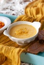 Close up Pumpkin soup cream in a white bowl spiced with curry. Delicius Pumpkin C