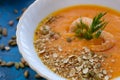 Close-up pumpkin soup with prawns, pumpkin seeds whole and broken and decorated with dill Royalty Free Stock Photo