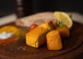 close-up of pumpkins served with other ingredients on wooden plate