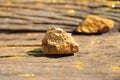 Close up pure gold minerals with golden light on old wooder background, investment and business concept Royalty Free Stock Photo