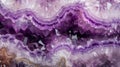 Close-up of a purple amethyst gemstone, displaying its layers and textures. Natural stones background