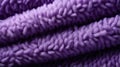 A close up of a purple blanket texture