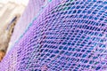 Violet and blue fishing net stack, maritime pattern background texture Royalty Free Stock Photo