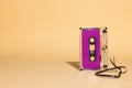 Close up of purple cassette tape with copy space on beige background