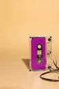 Close up of purple cassette tape with copy space on beige background