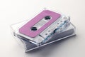 Close up of purple cassette tape and white box on white background Royalty Free Stock Photo