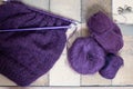 Purple mohair and alpaca yarn hand knitted sweater with stitches including stocking stitch and rib, on straight knitting needles. Royalty Free Stock Photo