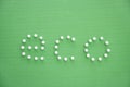 Close-up of push pins spelling eco over green background Royalty Free Stock Photo