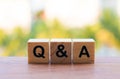 Close-up of q and a on a wooden cube