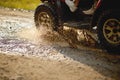 Close-up of quad wheels on the muddy road in the nature. Riding, nature, activity