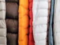 Close up of quilted sewing on puffy warm jackets hanging together