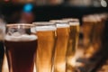 Close up of a rack of different kinds of beers, dark to light, on a table. Royalty Free Stock Photo