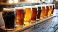 Close up of a rack of different kinds of beers, dark to light, on a table. Royalty Free Stock Photo