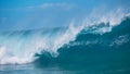 CLOSE UP: Raging barrel wave glimmers in the bright summer sunshine in Tahiti Royalty Free Stock Photo