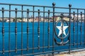 Close up of the railing in Taranto on blurred industrial site called Ilva background Royalty Free Stock Photo