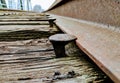 Close up of railroad spike holding train rails to ties Royalty Free Stock Photo