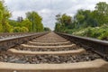 Close-up of railroad tracks leading straight foreward to infinity Royalty Free Stock Photo