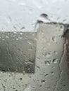 Raindrops on Window Blurring Urban View Behind Glass Royalty Free Stock Photo
