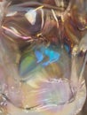 Close-up of a rainbow-colored, uneven glass surface as a background, wallpaper, texture photo. Royalty Free Stock Photo
