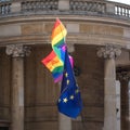 Close up of rainbow LGBT flag and EU flag flying together at the Gay Pride Parade in London 2018. Royalty Free Stock Photo