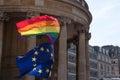 Close up of rainbow LGBT flag and EU flag flying together at the Gay Pride Parade in London 2018.