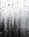 Close Up of Raindrops Streaking Down a Window on a Gray Day Royalty Free Stock Photo