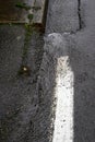 Close up of rainwater running down the edge of the street and sidewalk