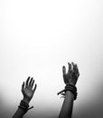 Tied hands raised to the sky