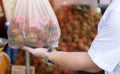 Close up of rambutan bag. An unidentified man buying rambutan at the local market