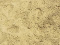Close up of rammed sandy clay ground with foot shoe print textures