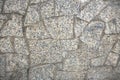 Decorative facing or sidewalk surface, made as asymmetric mosaic of gray granit pieces of different shapes. Royalty Free Stock Photo