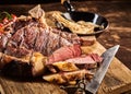 Close up on rare cooked cote de boeuf steak with knife