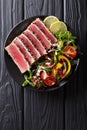 Close up of rare seared Ahi tuna slices with fresh vegetable sal Royalty Free Stock Photo