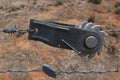 a close up of a ratchet style strainer for tightening the tension of wire farm fences on a blurry background Royalty Free Stock Photo