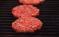 Raw beef burgers for hamburger on barbecue grill Royalty Free Stock Photo