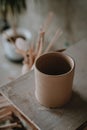Close-up raw ceramic pottery cup drying on wooden table, clay texture Royalty Free Stock Photo
