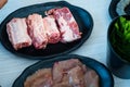 Close up of raw fresh pork ribs on black plate Royalty Free Stock Photo