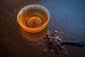 Close up of raw honey in a glass bowl on wooden surface along with powdered rock slat in a black colored spoon.Helps in getting go