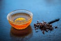 Close up of raw honey in a glass bowl on wooden surface along with powdered rock slat in a black colored spoon.Helps in getting go