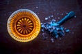 Close up of raw honey in a glass bowl on wooden surface along with powdered rock slat in a black colored spoon.Helps in getting go